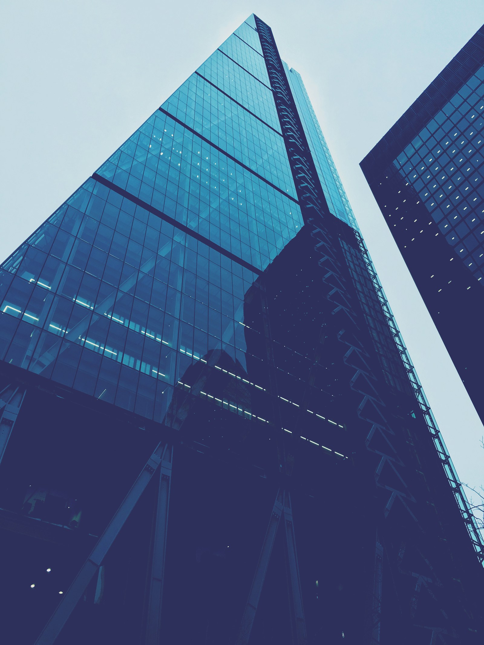 A city financial district skyline at dusk with lit office towers
