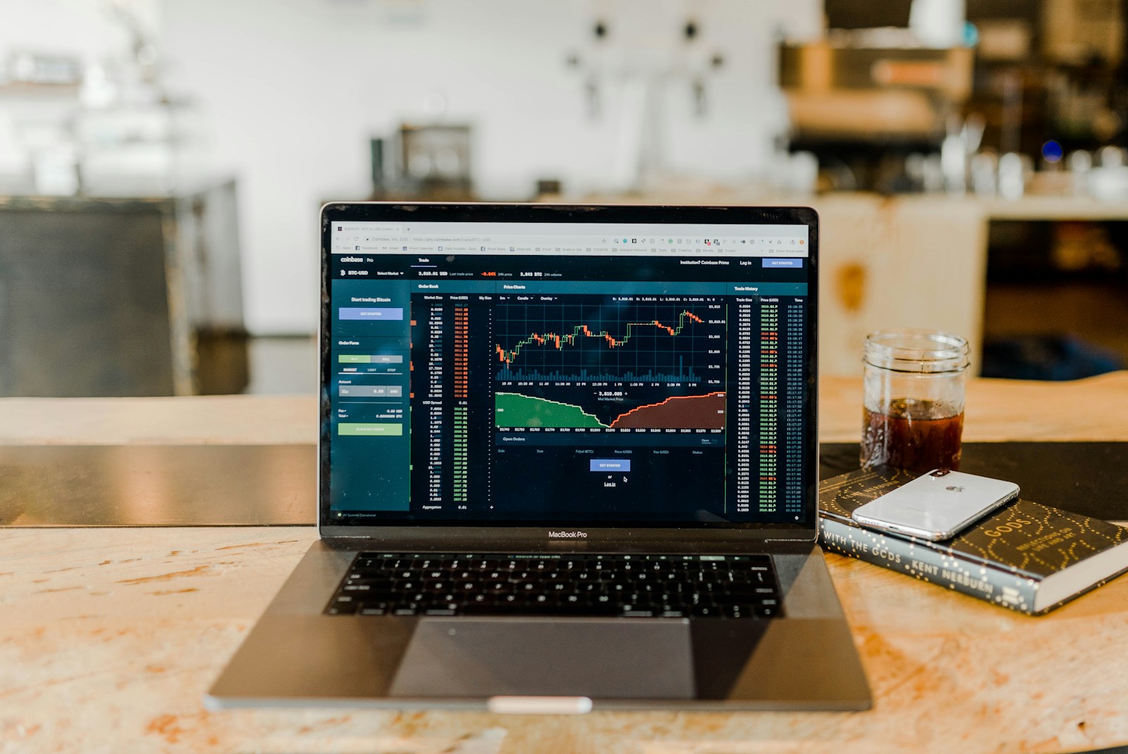 A stock exchange trading floor with monitors displaying tickers and price charts